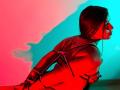 MelodyRoss, bound with red rope, has arms tied behind her back, sitting in profile, illuminated by red and blue light, showcasing her bare back and short brown hair.