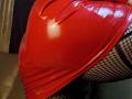 MoonDark69's shiny red latex butt in fishnet stockings. The latex is tight, highlighting the curves, and the fishnets add a textured contrast. MoonDark69's butt is prominent.