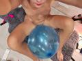 OrianaLaFrancaise is naked, sitting with legs spread, holding a blue exercise ball over her pussy. She has red lipstick, and her hands are near the top.