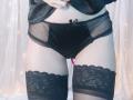 OrianaLaFrancaise's black lace panties and thigh-high stockings, showing her bare ass and a pink butt plug, with her hand lifting a black shirt.