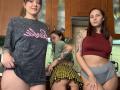 Three HotCaramelsTrio women in a kitchen, showing their asses. Left woman in grey shirt, middle woman in green shirt and yellow checkered skirt, right woman in red top and grey shorts.