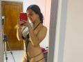 LonxEva with dark hair, small white earrings, black lace lingerie showing her tits and pussy, holding a red phone, taking a mirror selfie in a room with a tripod.