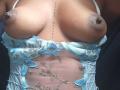 Caylin's boobs are exposed, with nipples pointing upward. She's wearing a blue lace-up lingerie top with butterfly patterns. Her brown skin has a vertical line of dots.