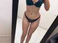 MoonLiza's tits are in a teal lace bra, and she's wearing matching teal lace panties. Her flat stomach and toned legs are visible in a mirror selfie.