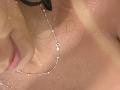 SarahPrincess's wet neck with droplets, silver chain necklace, and black glasses. Her lips are slightly visible on the left, with her collarbone and chest in the frame.