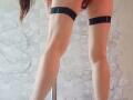IrunchaArt's bare ass is in the frame, wearing black thigh straps, with legs slightly apart, showing a clear view of her thighs and lower back.