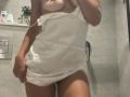 SandraSweet wearing a wet, white, sheer, baby-doll-style lingerie that reveals her tits and pussy through the transparent fabric, standing in a tiled shower.