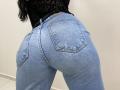 OliviaGranda's tight blue jeans show off her big ass, with visible back pockets and a black lace top, her black hair falling down her back.