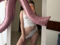 AlicePrings in a white tank top and grey panties, holding a pink balloon, taking a mirror selfie with her phone, showing her ass and pussy.