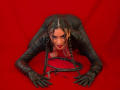 AdalinaVera, black shiny latex suit, braided hair, red background, on knees, hands forward, smiling, red lips, black gloves, ass up, looking at camera, sexy, seductive.