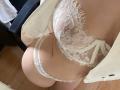 CharleenTilton's lace bra with floral patterns, showing her tits, and white lace panties, with her ass and a partially open white shirt on a wooden floor.