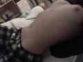 LanieDistel's topless torso with small nipples, pale skin, and a slight belly, wearing black and white checkered pants, lying on a bed.