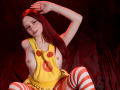 LesleyGray with red hair, yellow top with red eyes, and striped red-white thigh-highs, sitting with arm up, exposing small tits, on dark red cloth.