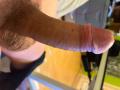 FrancimooR's erect, circumcised, pinkish-brown cock with a slightly curved tip and visible veins, showing a textured, hairy scrotum at the base.