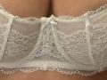 MargoFun's lace-covered boobs, detailed with floral patterns and a small white bow, are centered in the image. The lace is white and semi-transparent.