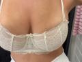 MargoFun's white lace bra is covering her big tits, showing a lot of cleavage. The bra has thin straps and a small bow in the center.