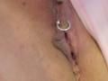 FrenchShanna's pussy with a silver ring piercing on her clitoral hood, visible in a detailed, close-up shot. Her skin is light brown with some visible texture.