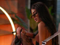 DariaAmaris with long dark hair, wearing sunglasses, pulling down black lace stockings, showing her bare ass and tits, in a sexy, provocative pose with a glowing circular light.