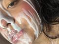 SammyTitss's face covered in thick, white cum, with pink flushed cheeks, shiny wet lips, and dark, wet hair. Her eye is slightly open, looking downward.