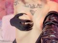 LaurenEvie69's bare tits, held by black latex gloves with sharp claws. She's wearing black latex sleeves. Tattoo above her tits is a diamond with "Diamant" text.