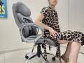 JoannaSia is sitting in a gray office chair, wearing a leopard-print dress, with her legs crossed, showing her bare ass and blue-painted nails.