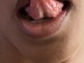 RoldanStefy's tongue is out, wet, and slightly glistening, with pink flesh and a small bit of white showing on the tongue's tip. RoldanStefy's lips are slightly parted.