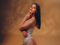 VirgieCrotts with brown hair, wearing a white one-piece, showing her ass, looking over her shoulder, hand on her neck, red lipstick, soft light, smooth skin.