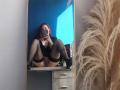 Mirror selfie of SweettEve with pink hair, black top, and black thigh-highs, sitting on a dresser, legs spread, exposing her pussy, holding a phone, puffy plant right.