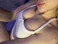 Olieri's white lace bra, showing her big tits with a small bow, and a tattoo on her right shoulder, with her lips slightly parted, under soft purple lighting.