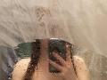 JannaCorsaro's naked torso and hand are visible through a wet, blurry shower glass, water droplets covering her chest and belly, with her nipples slightly visible.
