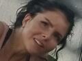 SofiaLiub has wet black hair, slightly parted lips, and a subtle smile. Her nose is slightly upturned, and she's wearing a pink top. Her tits are small and she's looking cute.