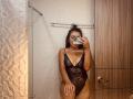AmeliRoux in a black lace bodysuit with deep V, showing her tits and pussy, taking a mirror selfie with a phone, standing in a bathroom.
