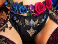 NenaBlack's black sheer panties with gold embroidery, blue and red roses, and purple leaves, showing her soft tan skin and upper thighs. Sheer black fabric with floral decorations.