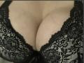 Barbarica's big, fluffy tits in a black lace bra. Her cleavage is prominent, with intricate lace patterns covering her large, round breasts. Her skin is fair.