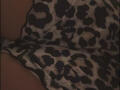 XimenaBella's ass is covered in a leopard print dress, with dark spots on a white background, shown in a dimly lit, close-up shot.