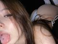 TaniaRaffa with tongue out, brown hair, tongue piercing, white panties, visible butt, lying down, facial close-up, slightly messy hair, light skin, relaxed, intimate, sensual.