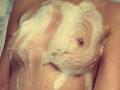 SarahFontain's wet, soapy tits covered in white foam, nipples visible, with soap bubbles and a wet, shiny chest. Her skin is light and she's standing in a shower.