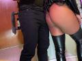 LilithAndAsmodeo's butt is exposed, wearing black leather thigh-highs and lace lingerie. LilithAndAsmodeo's black pants have a furry tail. The person's butt is tan and round.