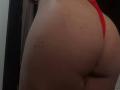 WendySchulz's butt in red thong, showing a few small dark moles on her tan, smooth skin. The focus is on her rounded, bare ass.