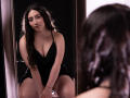 AnnFisher with long dark hair, wearing a black dress with a deep neckline, sitting in front of a mirror, reflecting her face and boobs, looking down, hands on knees.