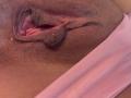 AlessiaFerry's pussy is shown in a close-up, with her labia and clitoral hood visible. Her skin is brown, and she's wearing pink fabric on the right.