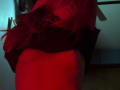 IrishReversed with red hair, lifting a black shirt to reveal a red, rounded butt. Red light casts a sexy glow on her smooth, curvy skin.
