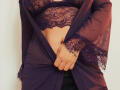XimenaBella's lace-covered tits and lace-trimmed robe are pulled open by her hand, revealing a bit of her belly and black pants. She's wearing a purple lace top.
