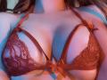 FlyFreedom's red lace bra with small bows is showing off her big, round tits. The bra is strappy and she's got a sexy, fair-skinned chest.