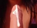 ZarayFeet's erect cock, covered in a thick white cum drip, is centered in the frame with dark wet hair on the right side.