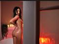 AmelieReea with shiny, oiled-up skin stands naked, showing her round ass and looking back with a seductive smile. She has long black hair and a sexy, confident look.