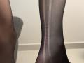 Tattiya's black, sheer, nylon-clad ankle with a visible seam and slight red mark, showing the texture and stretch of the fabric.