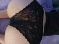 CatBleu's ass in black lace panties, showing a clear view of her buttcheeks and lace pattern, with her back slightly arched.