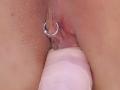 FrenchShanna's pink pussy with a silver ring on her clitoral hood, being penetrated by a white dildo. The dildo is partially inserted in her wet, pink vagina.