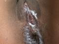 LisaMendez's wet, glistening pussy with visible cum dripping down her brown, hairy labia. Her pink inner pussy is slightly parted. Her hairy brown pussy is at the bottom.
